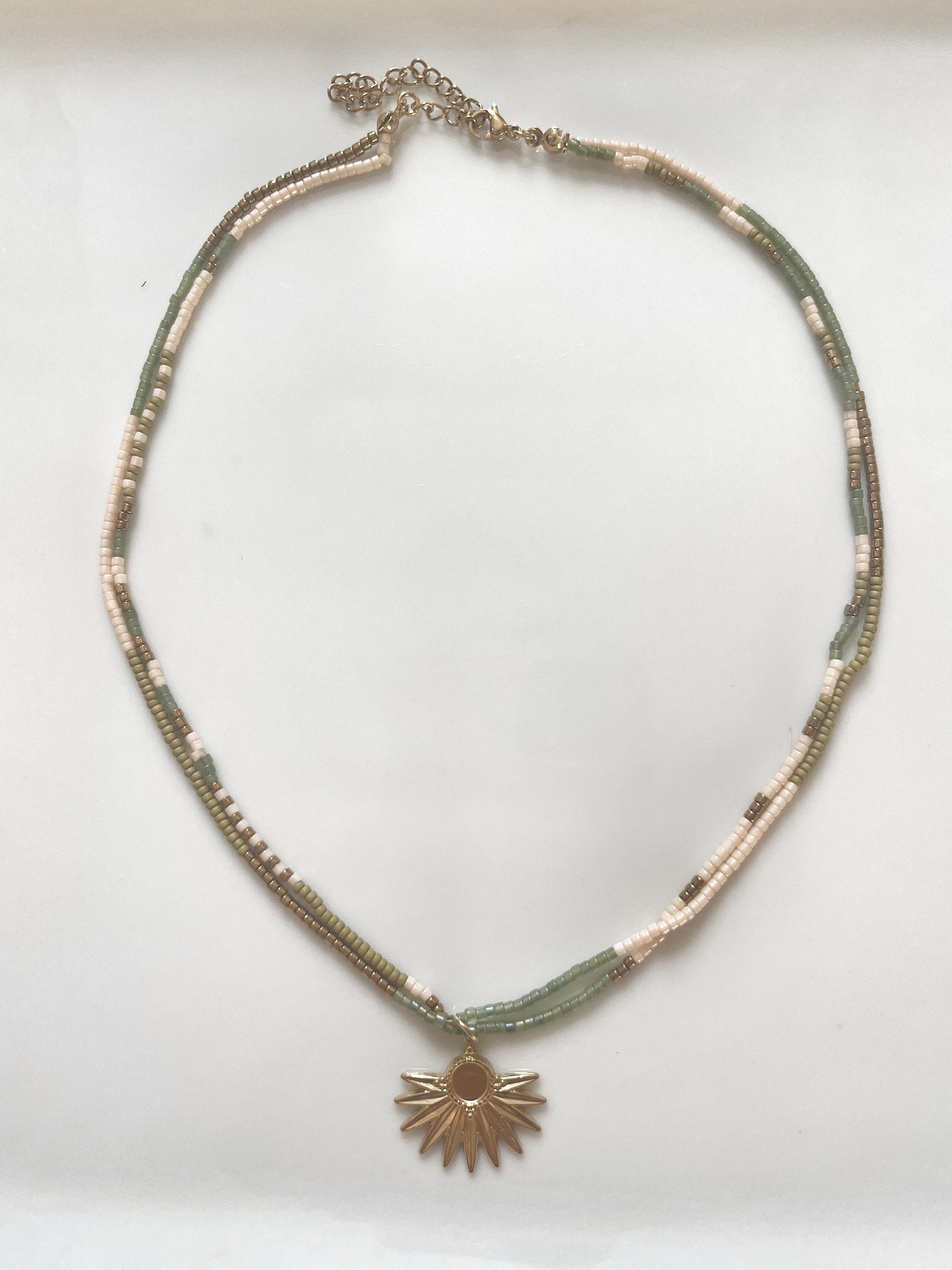 Collier de perle de verre avec pendentif en acier inoxydable.